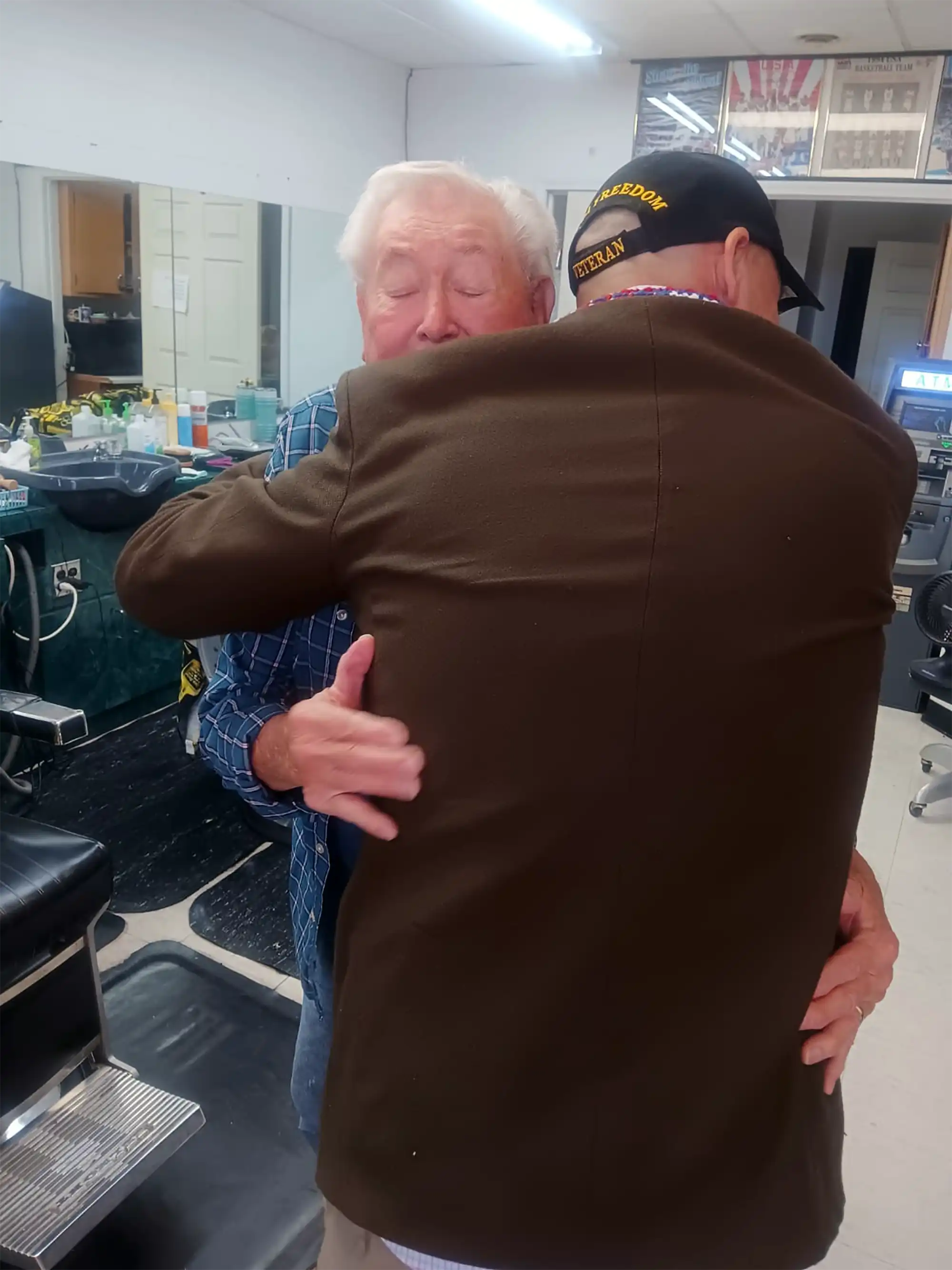 Veteran hugs at Mrs. Kim's barbershop, St. Robert, MO, USA.